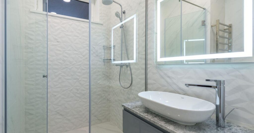 Modern remodeled bathroom with a glass walk-in shower and floating vanity in a Treasure Valley home